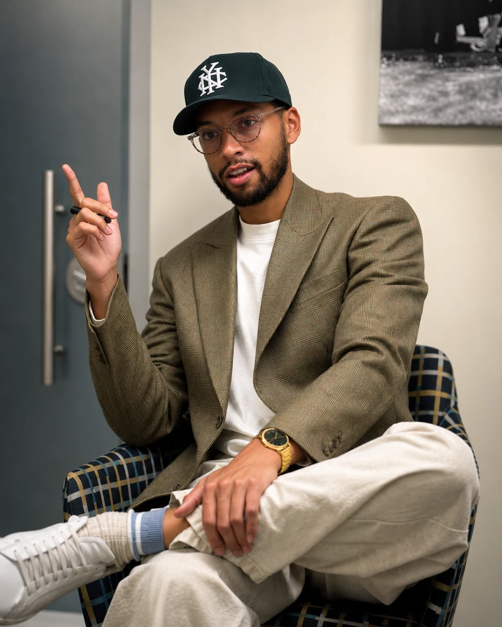 Lorenzo, Viewso cofounder, seated in a jacket and cap
